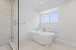 This bathroom features a modern freestanding bathtub paired with a sleek faucet, creating a spa-like ambiance.