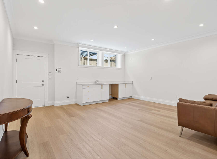 This spacious room features a stylish built-in cabinet, perfect for a home office or entertainment area.