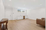 This spacious room features a stylish built-in cabinet, perfect for a home office or entertainment area.