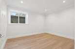 This is a bright and airy room with hardwood floors, white walls, and recessed lighting.