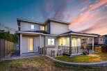 Stunning modern home with a spacious backyard, perfect for outdoor entertaining.