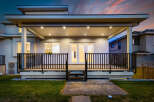 This stunning home boasts a covered deck, perfect for outdoor entertaining and relaxation.
