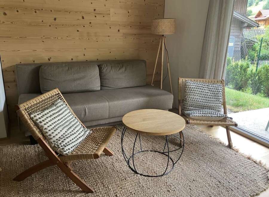 This cozy living room features a comfortable sofa, perfect for relaxing after a long day.