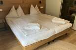 Experience ultimate comfort in this inviting hotel room, featuring a plush bed with crisp white linens and soft pillows.