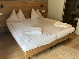 Experience ultimate comfort in this inviting hotel room, featuring a plush bed with crisp white linens and soft pillows.