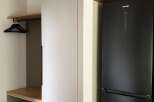 This property boasts modern built-in storage solutions, including a sleek white closet perfect for organizing belongings.