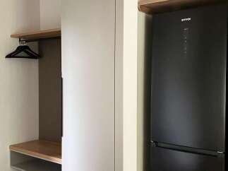 This property boasts modern built-in storage solutions, including a sleek white closet perfect for organizing belongings.