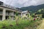 These modern apartments offer a serene retreat with balconies overlooking lush greenery and mountain views.