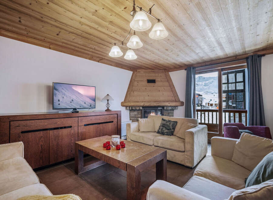 This inviting living room features a cozy fireplace, perfect for relaxing after a day on the slopes.