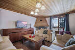 This inviting living room features a cozy fireplace, perfect for relaxing after a day on the slopes.