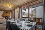 This inviting dining area boasts a beautifully set table perfect for meals with a view.