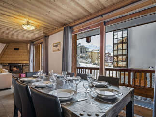 This inviting dining area boasts a beautifully set table perfect for meals with a view.