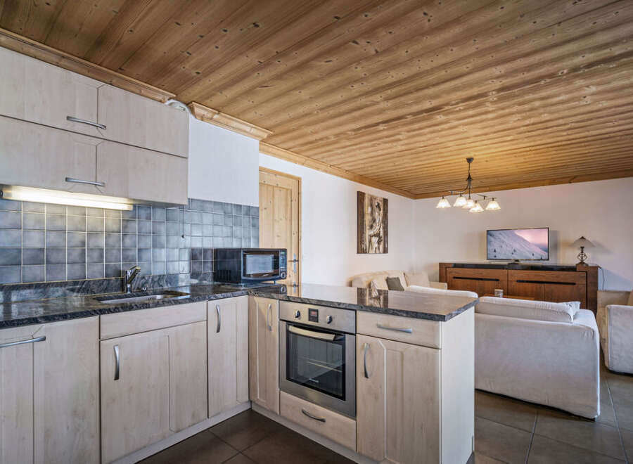 This inviting chalet features a well-equipped kitchen with sleek countertops and modern appliances.