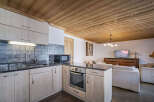 This inviting chalet features a well-equipped kitchen with sleek countertops and modern appliances.