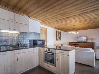 This inviting chalet features a well-equipped kitchen with sleek countertops and modern appliances.