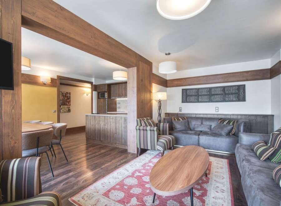 This inviting living space showcases a blend of rustic charm and modern comfort, perfect for families.