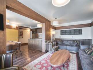 This inviting living space showcases a blend of rustic charm and modern comfort, perfect for families.