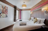 Experience comfort in this inviting bedroom featuring twin beds with crisp white linens and cozy throw pillows.
