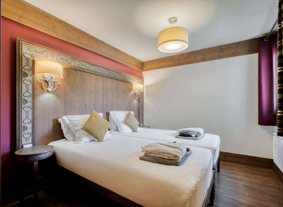 This is a cozy bedroom in a property with two twin beds, perfect for a comfortable stay.