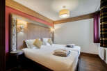 This is a cozy bedroom in a property with two twin beds, perfect for a comfortable stay.