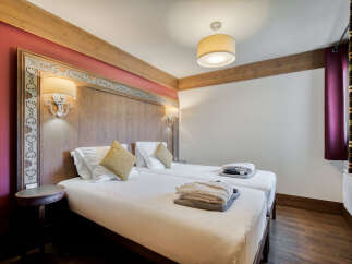 This is a cozy bedroom in a property with two twin beds, perfect for a comfortable stay.