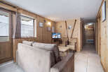 Discover this charming ski chalet-style living room, featuring cozy wood-paneled walls that create a warm and inviting atmosphere.