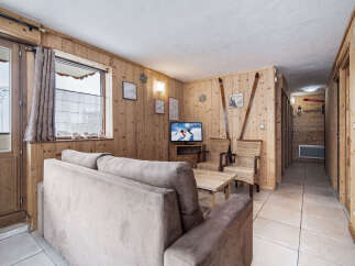 Discover this charming ski chalet-style living room, featuring cozy wood-paneled walls that create a warm and inviting atmosphere.