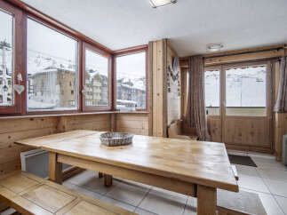 This room features a wooden table and bench seating perfect for enjoying meals with mountain views.