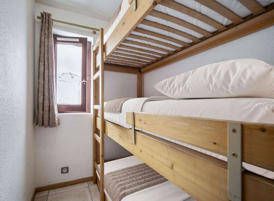 This room features a space-saving triple bunk bed, perfect for families or groups.