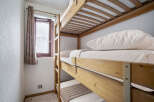 This room features a space-saving triple bunk bed, perfect for families or groups.