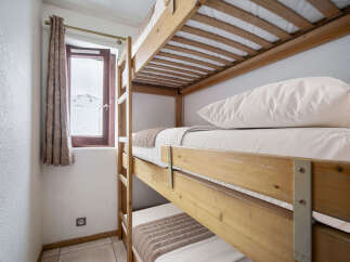 This room features a space-saving triple bunk bed, perfect for families or groups.
