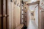 This hallway features natural wood paneling, creating a warm and inviting atmosphere.