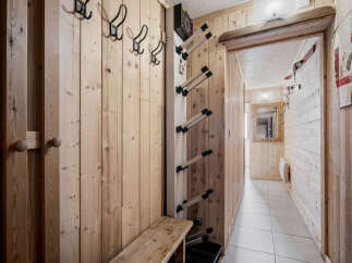 This hallway features natural wood paneling, creating a warm and inviting atmosphere.