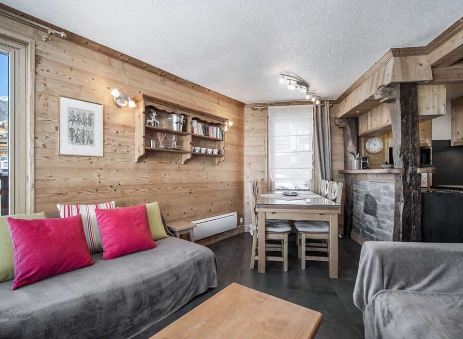 This charming living area features rustic wood paneling, creating a warm and inviting ambiance.
