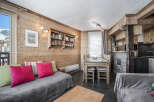 This charming living area features rustic wood paneling, creating a warm and inviting ambiance.