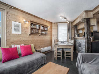 This charming living area features rustic wood paneling, creating a warm and inviting ambiance.
