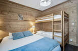 This cozy bedroom features rustic wooden walls that create a warm and inviting atmosphere.