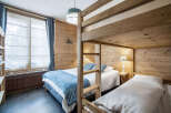 This cozy bedroom features charming wood paneling, creating a warm and inviting atmosphere.