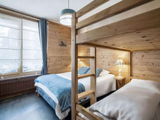This cozy bedroom features charming wood paneling, creating a warm and inviting atmosphere.