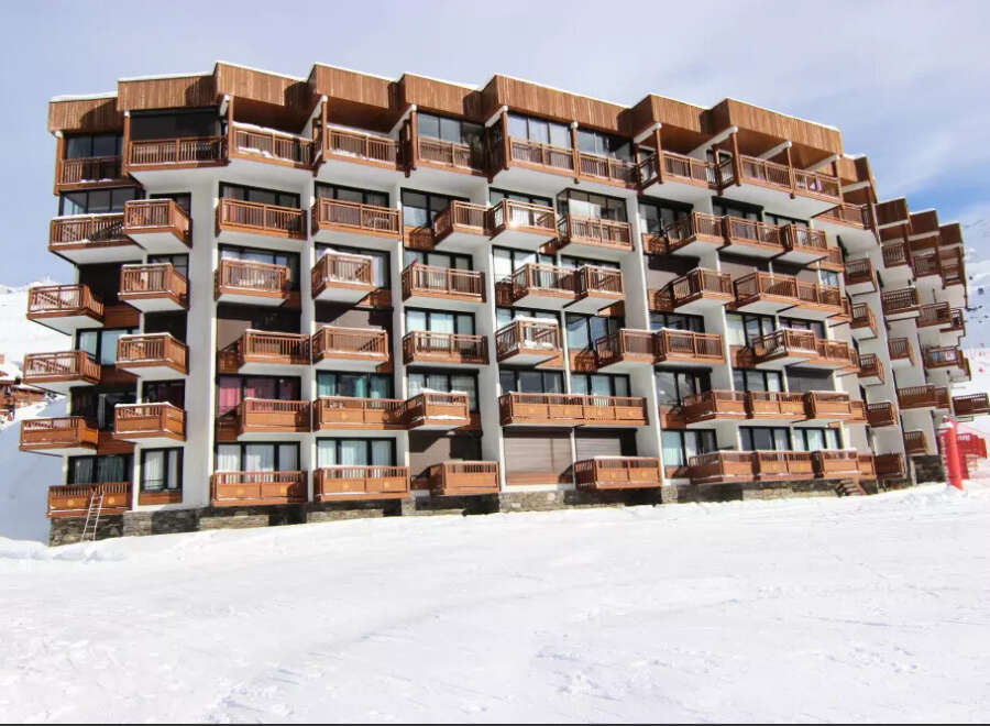 Ski-in/ski-out condo building featuring private balconies with mountain views.