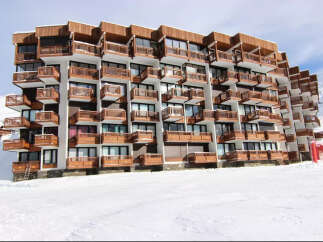 Ski-in/ski-out condo building featuring private balconies with mountain views.