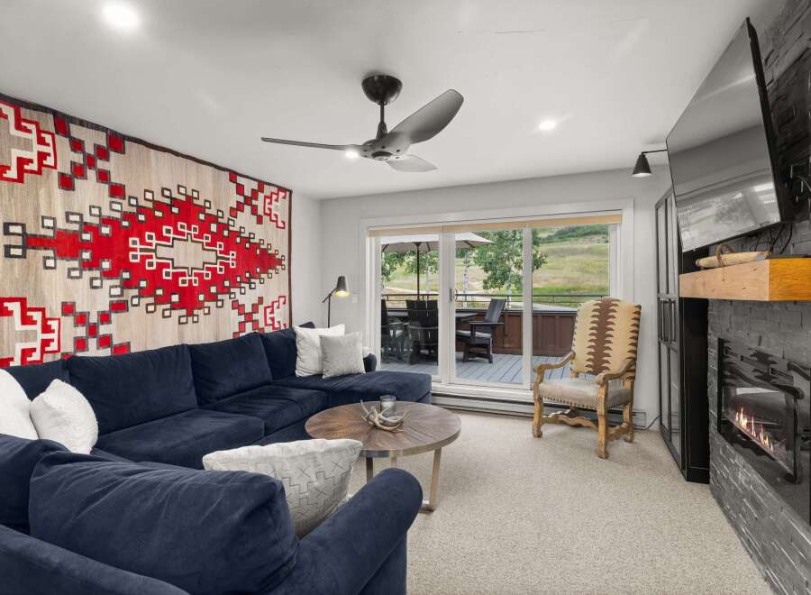 This inviting living room boasts a plush blue sectional, perfect for relaxation.