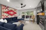 This inviting living room boasts a plush blue sectional, perfect for relaxation.