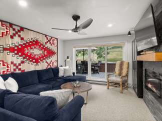 This inviting living room boasts a plush blue sectional, perfect for relaxation.