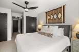 This bedroom features a comfortable bed with soft white linens and decorative pillows.