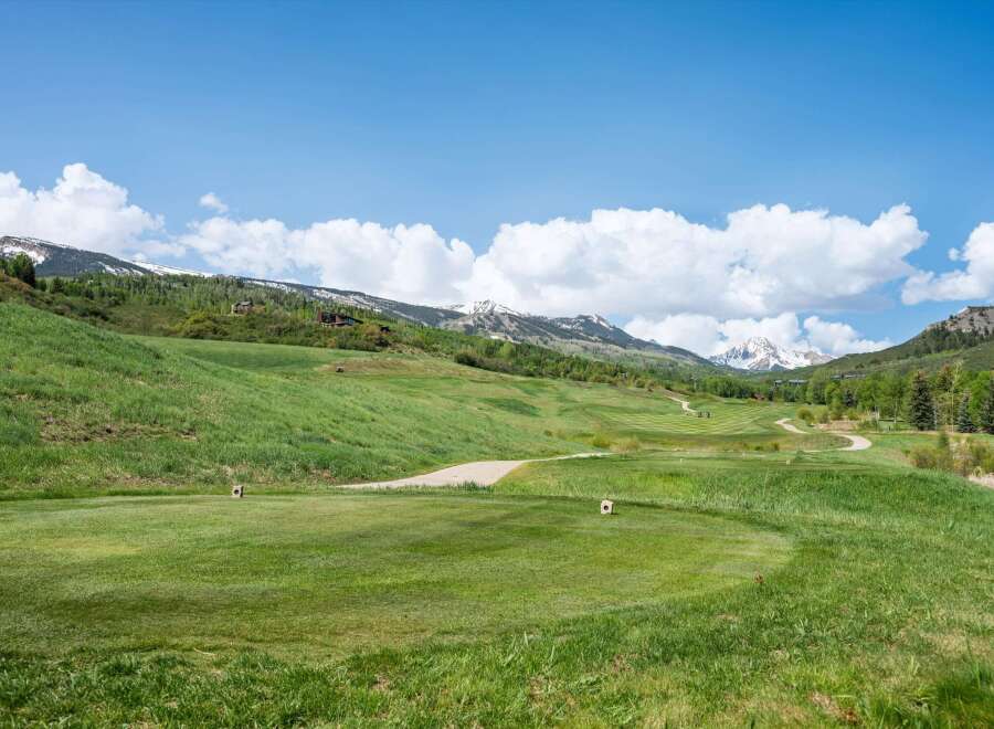 Discover luxury real estate nestled in a picturesque golf course community with stunning mountain views.