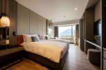 Indulge in the comfort of this hotel room featuring twin beds, a large window with scenic mountain views, and modern decor.