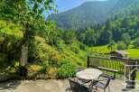 Discover this serene mountain retreat with lush greenery and stunning views.