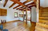 Rustic charm meets modern living in this unique property featuring exposed wooden beams, hardwood floors, and a cozy wood-burning stove.