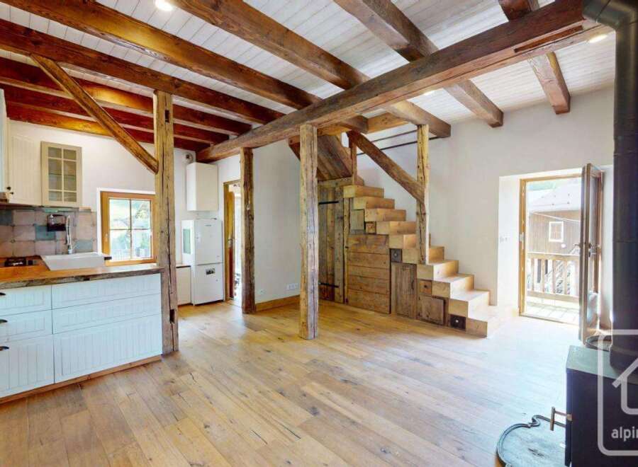 This inviting property boasts a rustic charm with exposed wooden beams and hardwood floors.